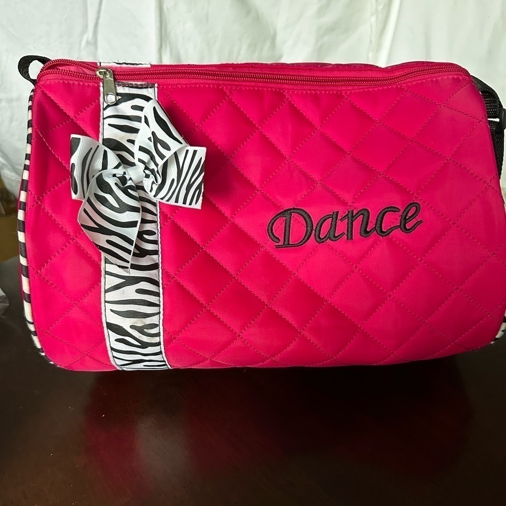 Pink dance bag with zebra print accent.